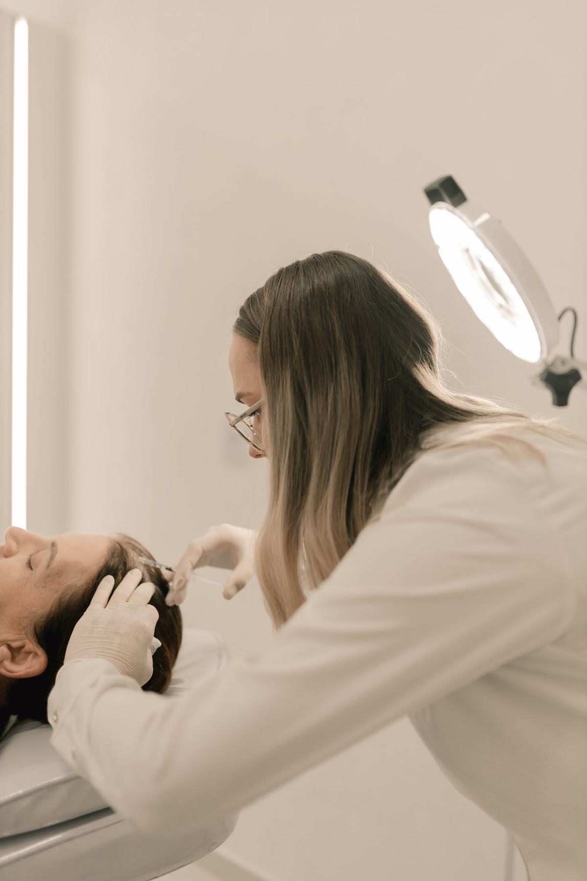 Dermatologist examining a lesion with a dermatoscope